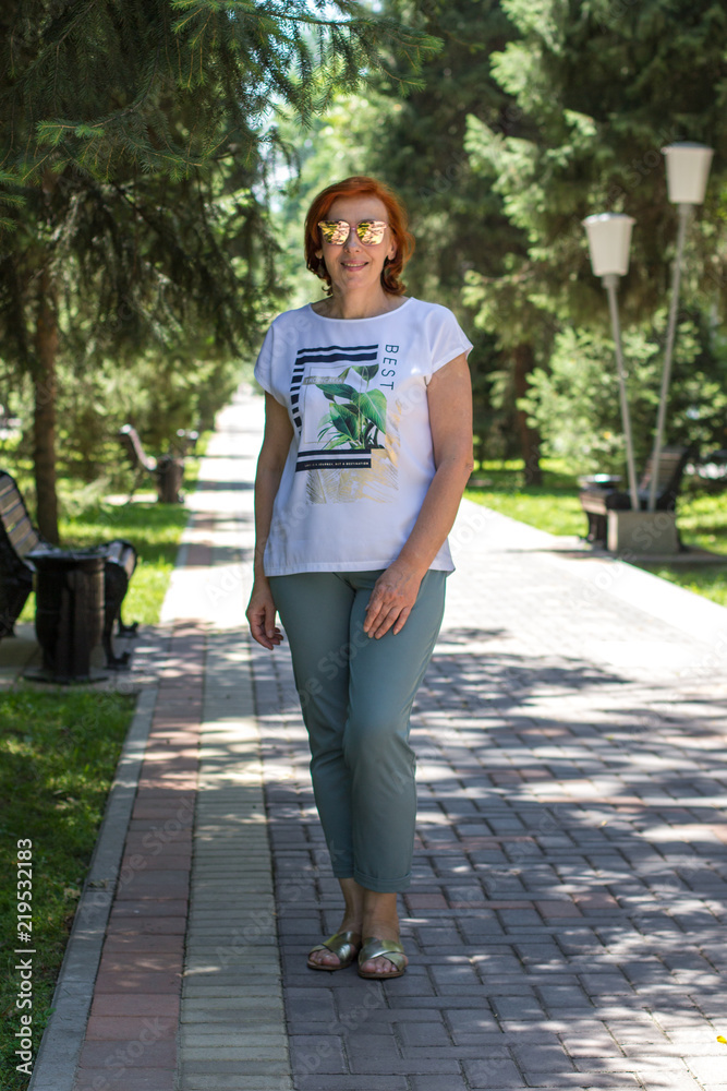 Fototapeta premium elderly woman with red hair on the street