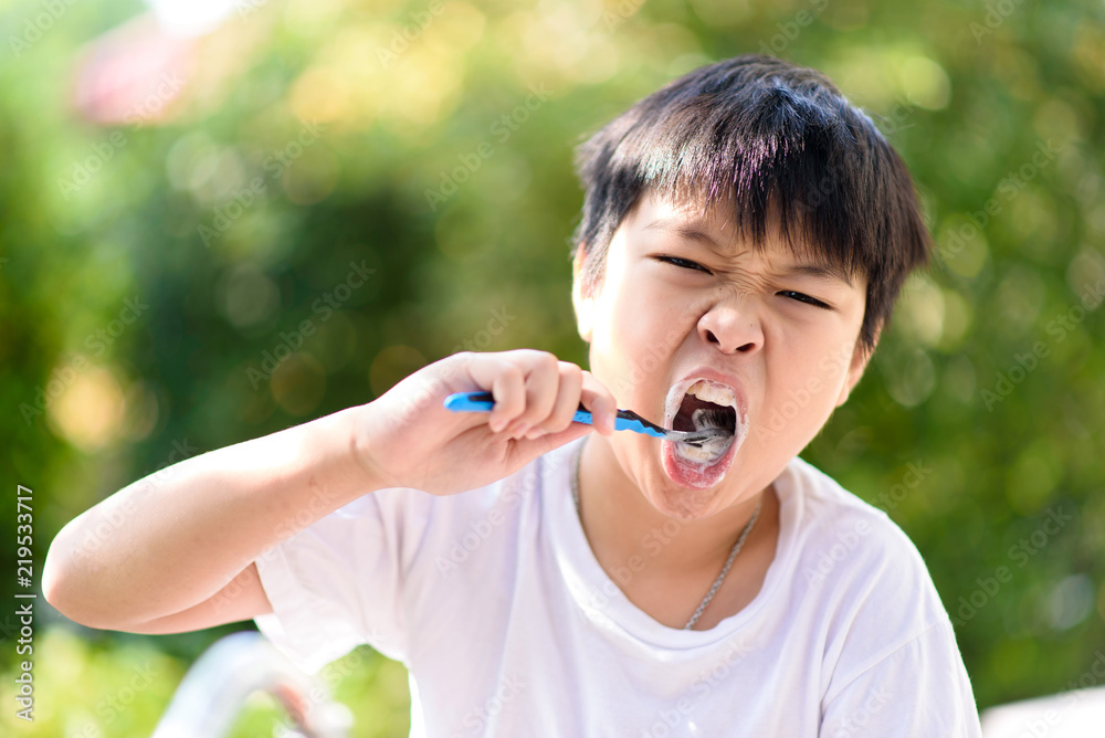 Preteen Asian boy brush his teeth Preteen Asian boy brush his teeth