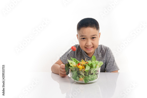 Young boy eat salad