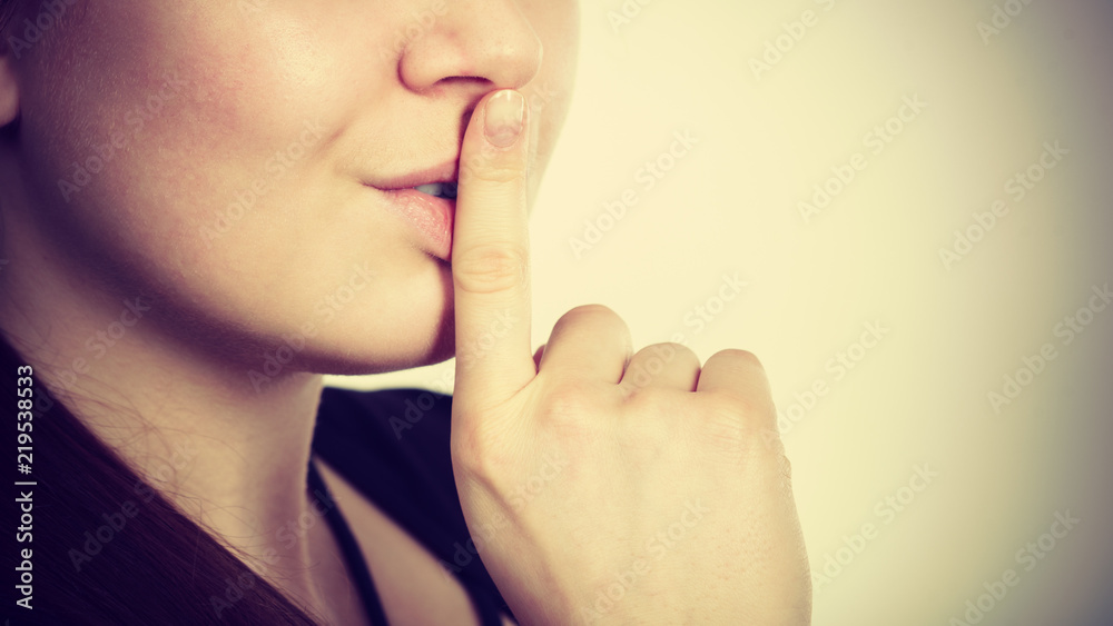 Woman showing silence gesture with finger Woman showing silence gesture with finger