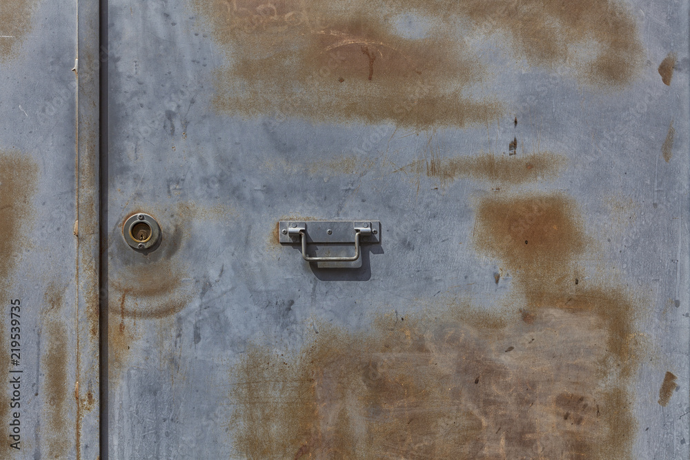 Closeup metal door with lock in grungy style and good texture Closeup metal door with lock in grungy style and good texture