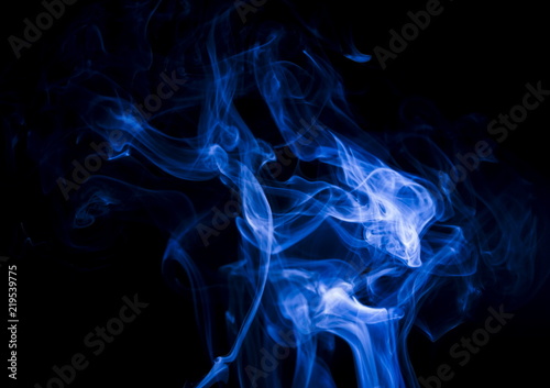 Blue smoke on black background