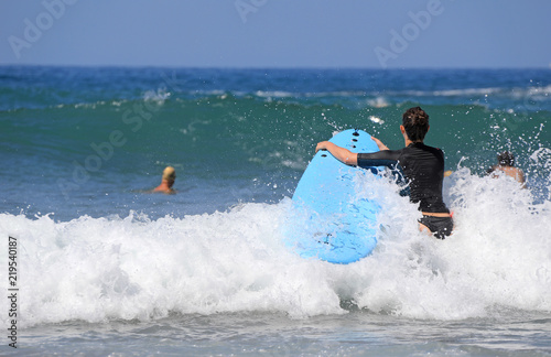 mujer surfista metiendose en el agua país vasco 4M0A0914-f18 photo