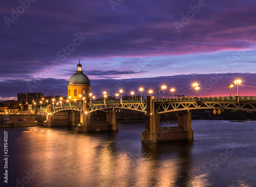 Saint Pierre bridge and Saint Joseph Chapel at sunset. Amazing reflection in the river Garonne. Toulouse, France. Europe. Long exposure photography