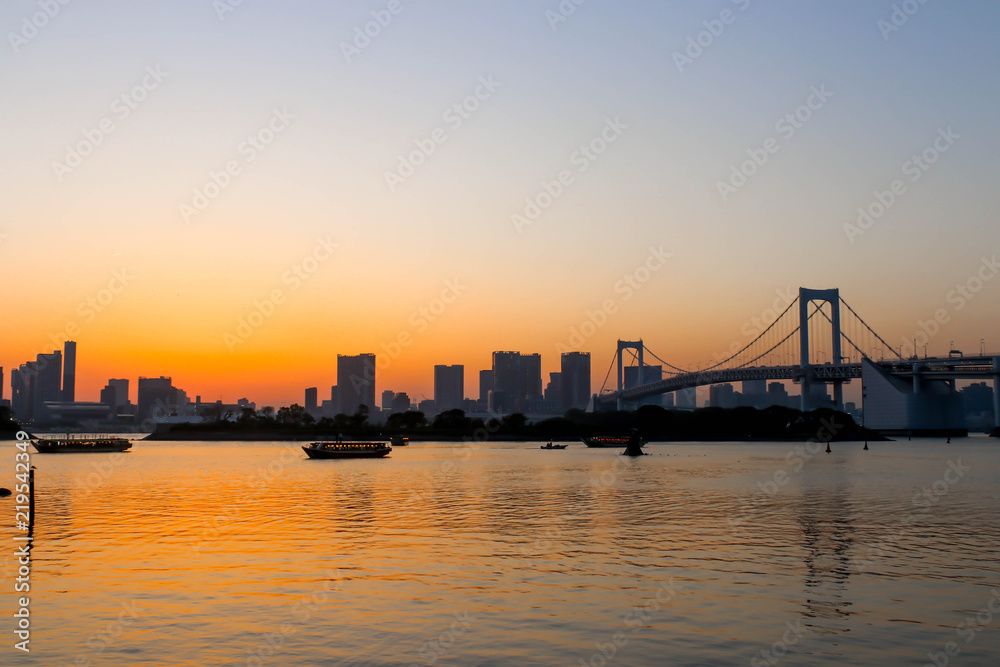 View of sunset and three boats and rainbow bridge at sumida river sunset viewpoint ,tokyo