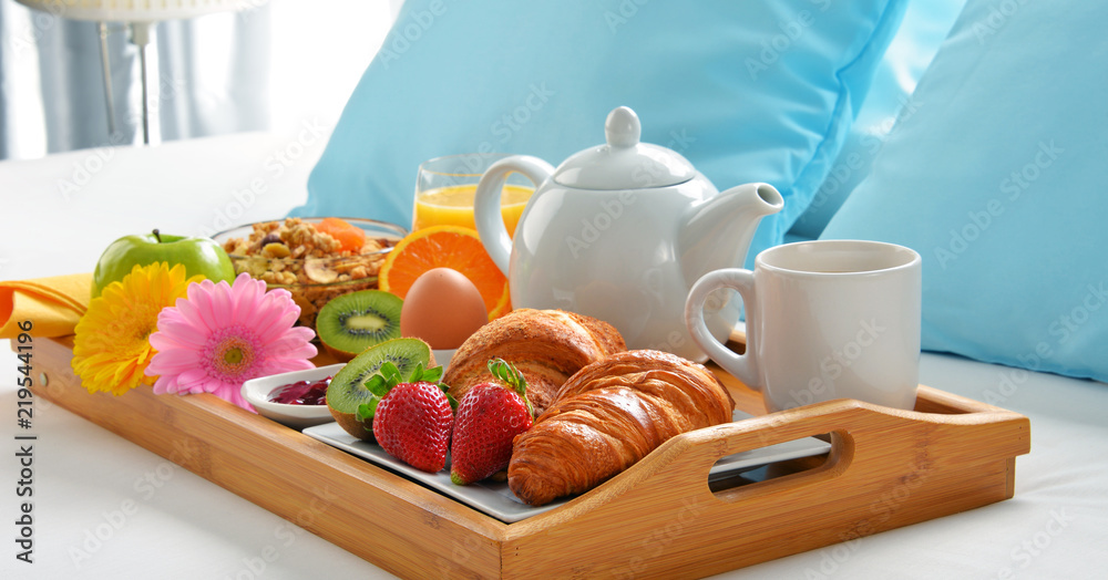 Breakfast tray in bed in hotel room Breakfast tray in bed in hotel room