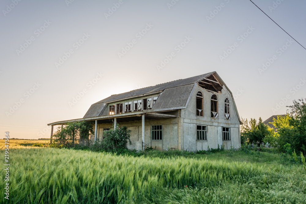 Abandoned building at sunset in summer, Ukraine, Shagany village Abandoned building at sunset in summer, Ukraine, Shagany village