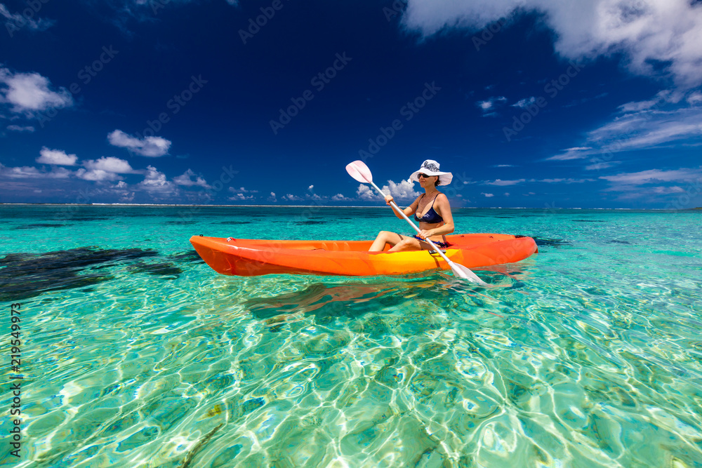 Woman Kayaking in the lagoon of tropical Samoa Islands