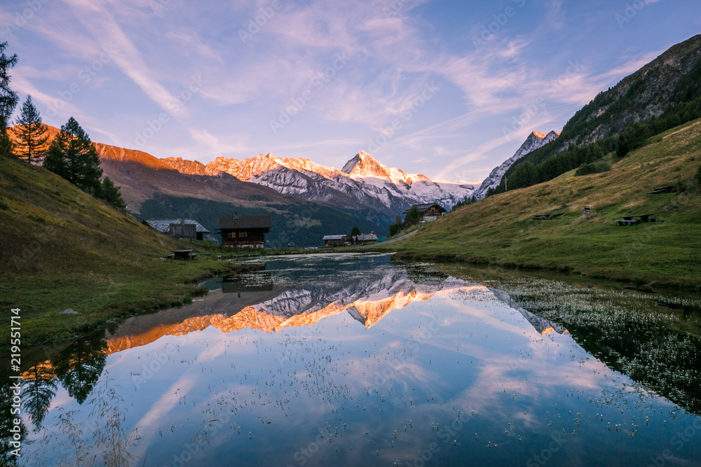 Crimson Sunset over Dent-Blanche Snowy Mountain Reflecting in Arbey Lake in Valais.