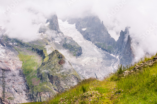 Iconic Mont-Blanc Glacier in Clouds in Green Mountain Landscape