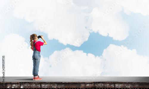 Concept of careless happy childhood with girl of school age looking in future