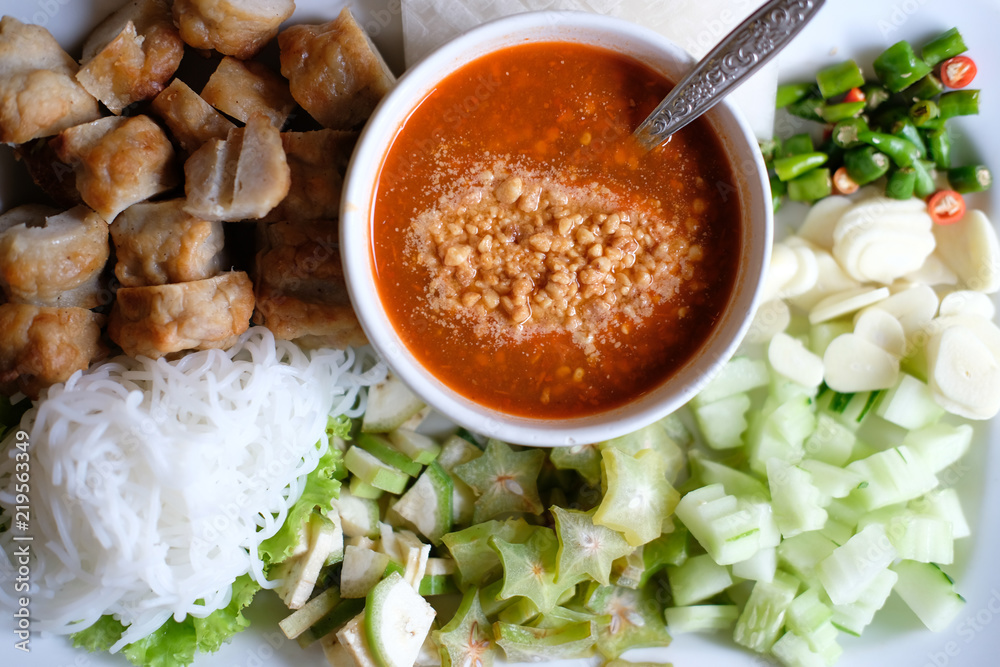 minced pork sausage, fermented rice noodle & vegetable served with chili sauce. vietnamese food called Nem Nuong Xa minced pork sausage, fermented rice noodle & vegetable served with chili sauce. vietnamese food called Nem Nuong Xa