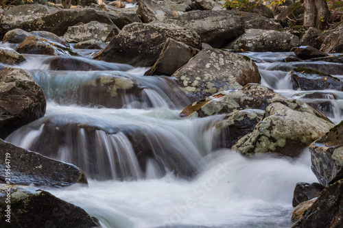 Multiple cascades of water across lichen covered rocks in the Great Smoky Mountains  horizontal aspect