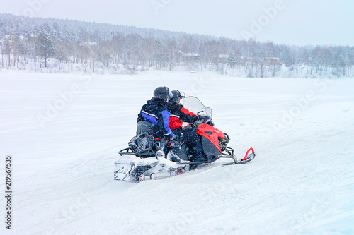 People in Snowmobile at Winter Finland Lapland during Christmas