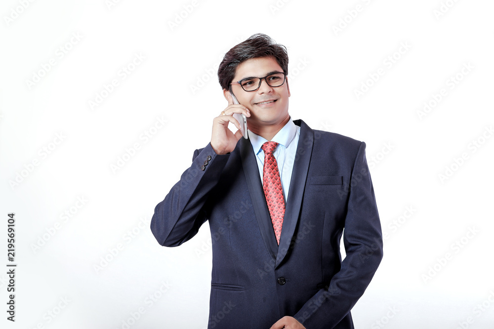 Young Indian businessmen talking on mobile over isolated background Young Indian businessmen talking on mobile over isolated background