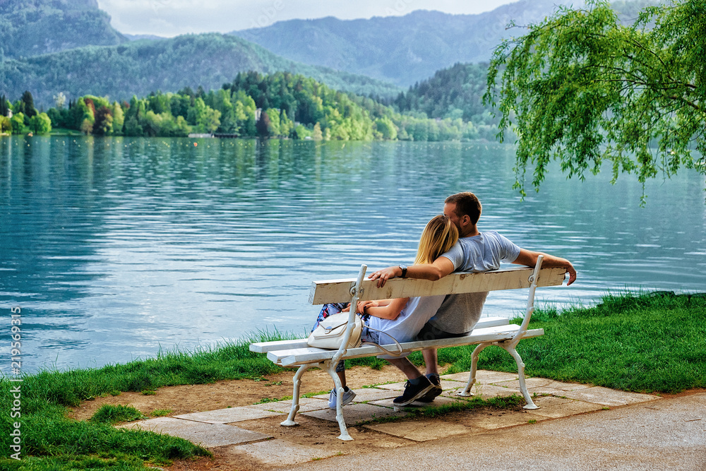Romantic couple sitting on bench at Bled Lake Slovenia Romantic couple sitting on bench at Bled Lake Slovenia