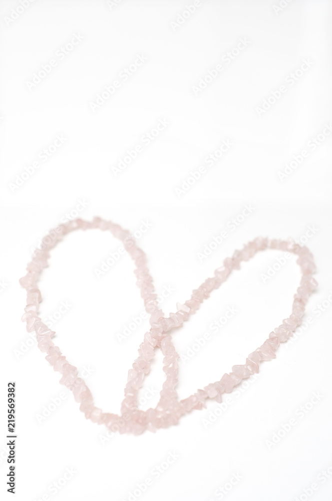 This heart shaped love pattern or background was created for Valentine's Day and was made of rose quartz crystal necklace.