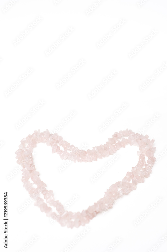 This heart shaped love pattern or background was created for Valentine's Day and was made of rose quartz crystal necklace.