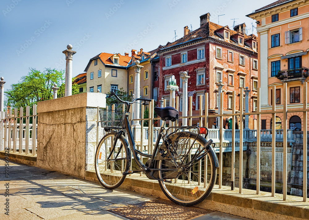 Bicycle at the embankment of Ljubljanica River in Ljubljana