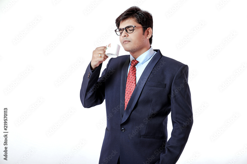 Young Indian businessman drinking a coffee over white background Young Indian businessman drinking a coffee over white background