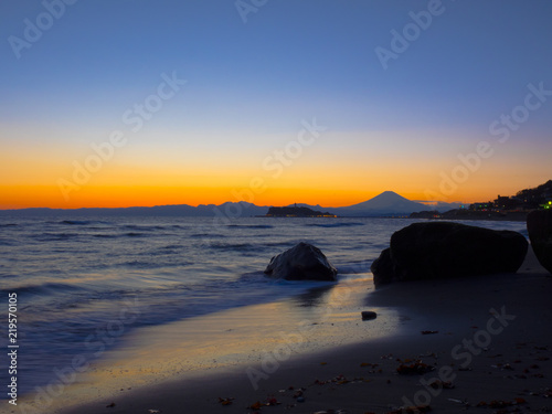 Mt. Fuji from the seaside at dusk. The mountain in the back is Mt. Fuji in Japan.The beachfront is very beautiful. In addition, the sunset is also very beautiful. © Tom Spark
