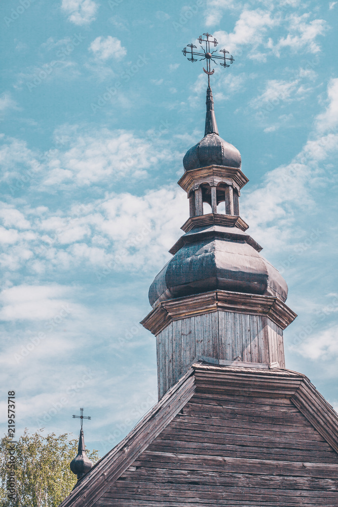Dome of an ancient wooden church on a sky background Dome of an ancient wooden church on a sky background