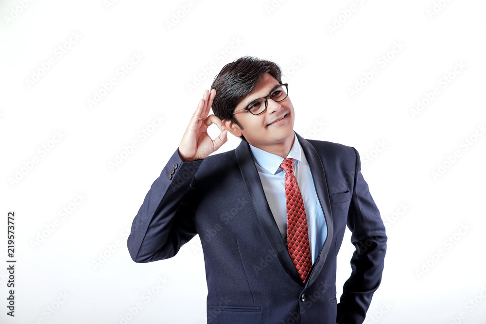 Young Indian businessman making an OK gesture over isolated white background Young Indian businessman making an OK gesture over isolated white background