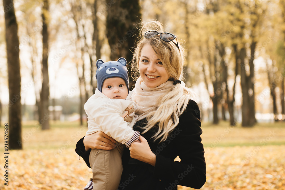 Portrait of a young mother with her baby in the autumn Park. Portrait of a young mother with her baby in the autumn Park.