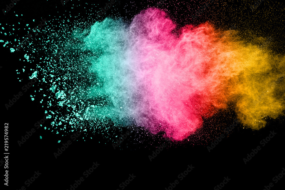 Multicolored powder explosion on black background.