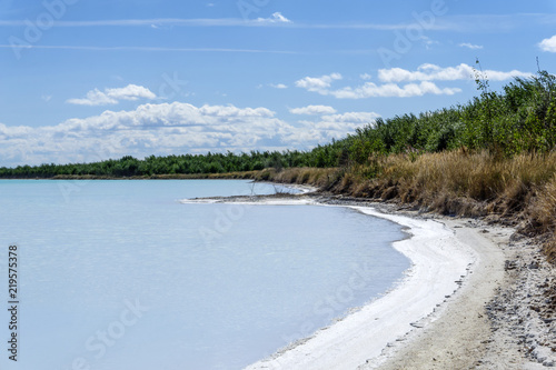 shore of a salty lake with a crust of salt along the coastline