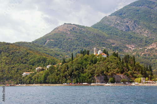 Cloudy Mediterranean landscape. Montenegro, Bay of Kotor, Adriatic Sea. View of Kamenari village with Church of Sveta Nedjelja