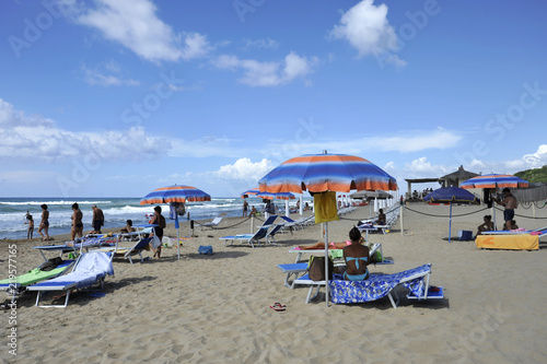 Relaxed people on the Sabaudia beach for the summer holidays. The sea on the background. Sabaudia, Lazio, Italy.