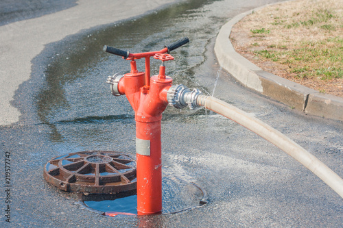 open fire hydrant with hose connected