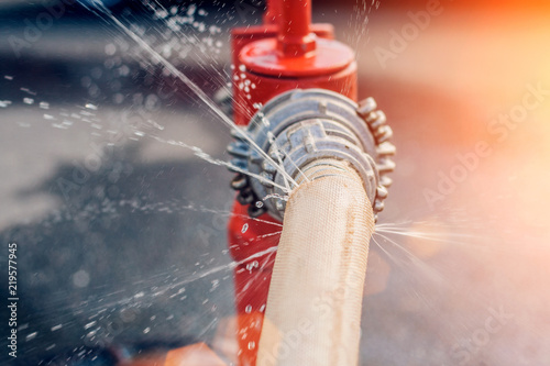 The flow of water and puddles from an open fire hydrant photo