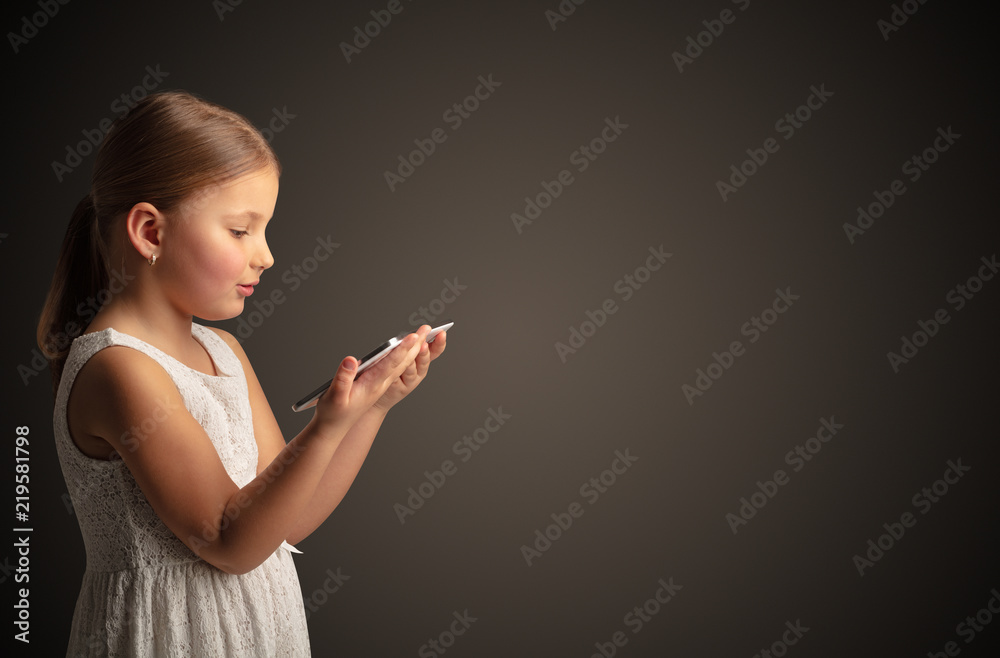 Adorable little girl using tablet with dark empty space
Adorable little girl using tablet with dark empty space