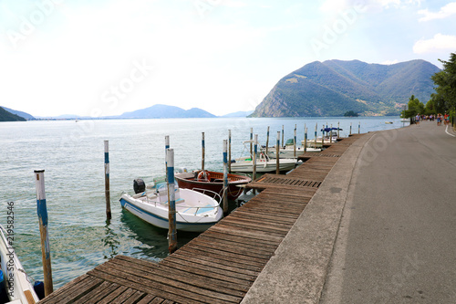 Boats moored in Peschiera Maraglio with Lake Iseo on the background, Monte Isola, Italy photo