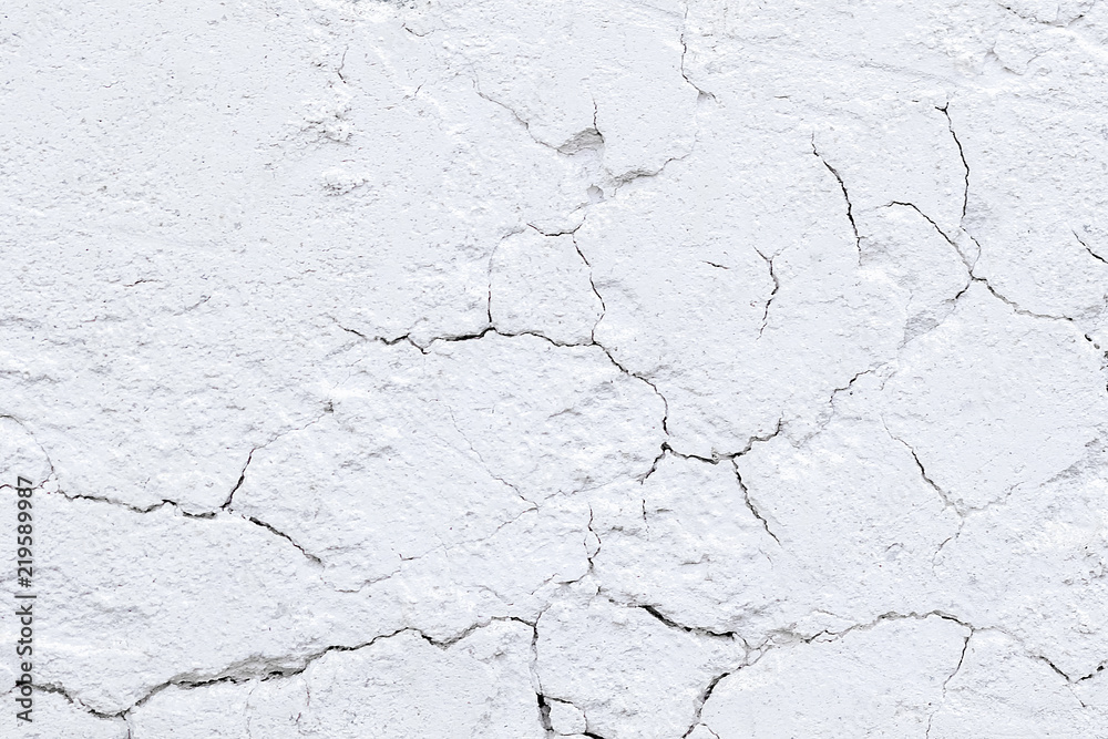 Rough old plaster on a brick wall. White gray abstract background. Rough old plaster on a brick wall. White gray abstract background.