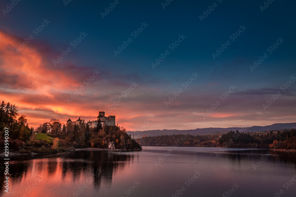 Stunning dusk over castle by the lake in Niedzica