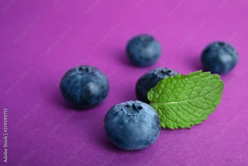 Tasty ripe blueberry on color background, closeup Tasty ripe blueberry on color background, closeup