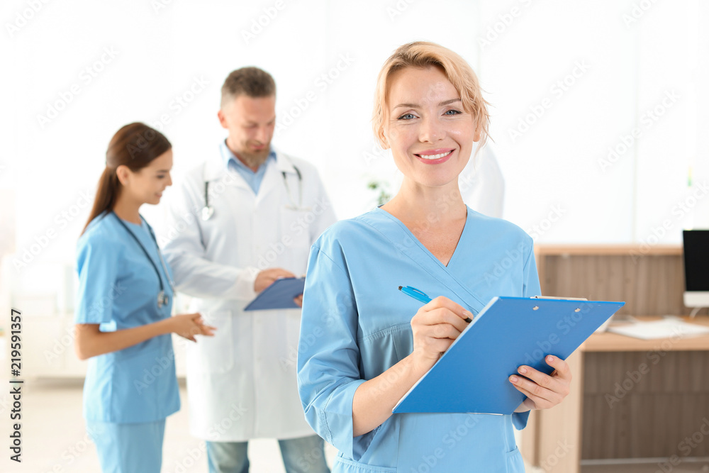 Medical assistant with colleagues in clinic. Health care service Medical assistant with colleagues in clinic. Health care service
