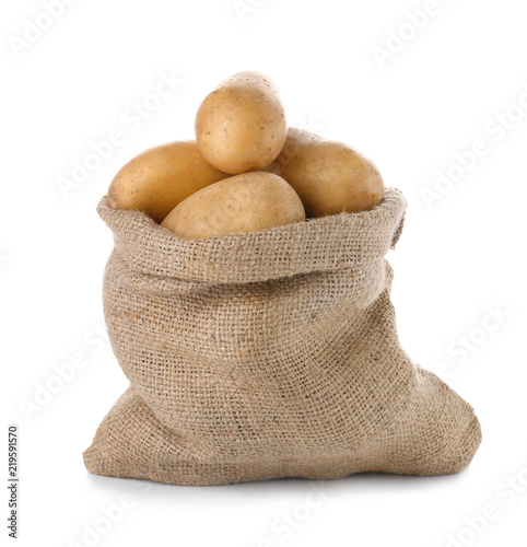 Sack with fresh ripe organic potatoes on white background