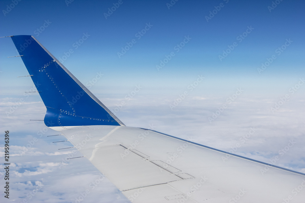 Airplane Wing Overlooking Clouded Earth