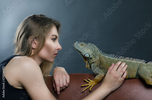 perfect portrait beautiful girl and big green iguana