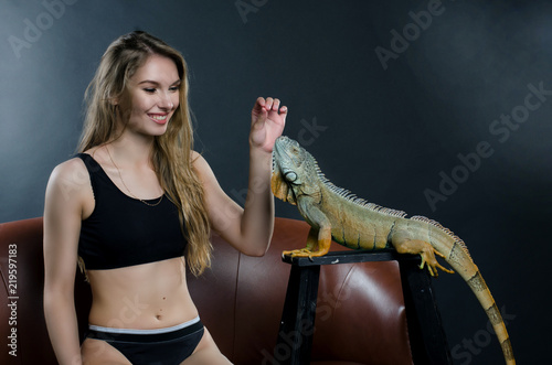 perfect girl and green iguana in the studio
