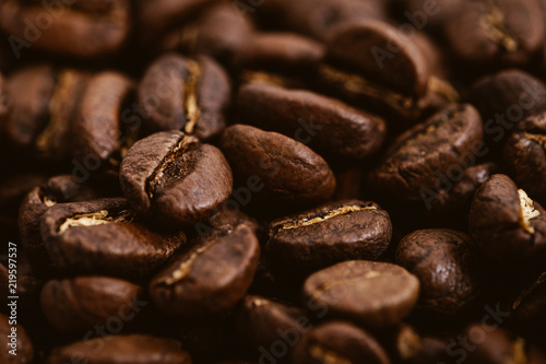 Coffee beans roasted on a wooden table with much of beans with a great aroma © Christian