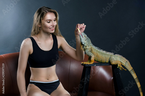perfect girl and green iguana in the studio
