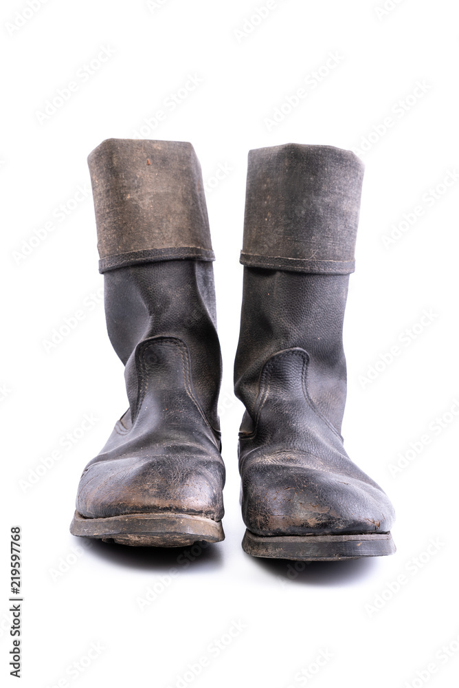 Kirza boots on white background, retro boots, made of artificial leather, used in Soviet Union for soldiers in the army and for work