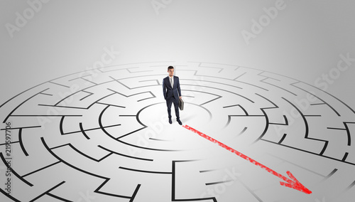 Businessman going through the maze with red arrow 