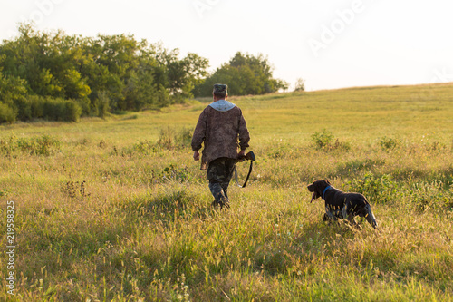 Hunter with a German trotter and spaniel, hunting a pheasant with dogs © Mountains Hunter