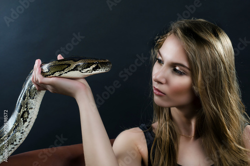 sensyal girl and tiger python in the studio

